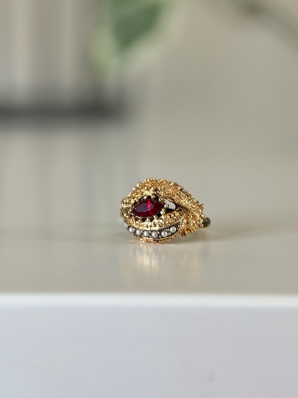 Vogue Gold-Tone Ring with Deep Red Center Stone